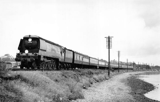 BR(S) West Country class 34046 'Braunton' at St Denys, Hampshire with a Brighton - West of England service on Saturday 14 Sep 1957 - J.H.W. Kent [001939]