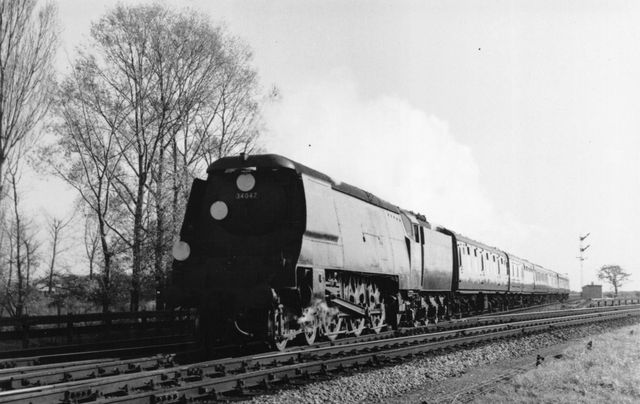 BR(S) West Country class 34047 'Callington' at Cosham Junction, Hampshire with a Brighton - Bournemouth West service on Saturday 02 Nov 1957 - J.H.W. Kent [001957]