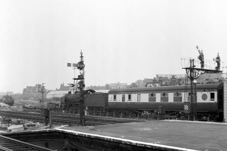 BR(S) N class 31411 at Clapham Junction Station, Greater London with a South Coast - LMR via Kensington Olympia service on Saturday 14 Jul 1951 - J.H.W. Kent [025123]