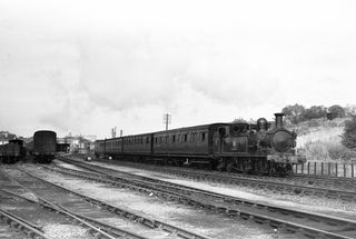 O2 class W25 'Godshill' at Ryde St Johns Road, Isle of Wight with the 3.35pm Ryde Pier Head - Cowes service on Saturday 08 Sep 1956 - J.J. Smith [040648]