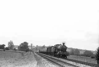 BR Manor class 7810 'Draycott Manor' near Mottisfont, Hampshire with the 10.15am Cheltenham - Southampton service on Saturday 05 Oct 1957 - C. Hogg [048991]