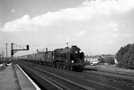 BR(S) Lord Nelson class 30864 'Sir Martin Frobisher' & BR(S) S15 class at Raynes Park Station, Greater London with a Bournemouth - Waterloo service on Saturday 13 Sep 1952 - J.H.W. Kent [090603]
