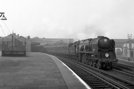 BR(S) Battle of Britain class 34050 'Royal Observer Corps' at Clapham Junction Station, Greater London with a West of England - Waterloo service on Saturday 04 Apr 1959 - J.H.W. Kent [092343]