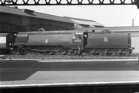 BR(S) Battle of Britain class 34063 '229 Squadron' at Clapham Junction Station, Greater London with an Empty stock to Waterloo on Saturday 25 May 1957 - J.H.W. Kent [094423]