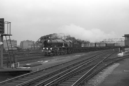 BR(S) Battle of Britain class 34052 'Lord Dowding' at Clapham Junction Station, Greater London with the 12.10pm Derby Day Royal Train from Victoria to Tattenham Corner on Wednesday 03 Jun 1964 - J. Scrace [141403]