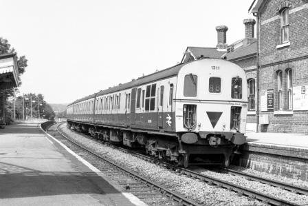 BR(S) Class 207 1311 at Buxted Station, East Sussex with the 1.24pm Victoria - Uckfield service on Saturday 13 Jul 1985 - J. Scrace [233716]