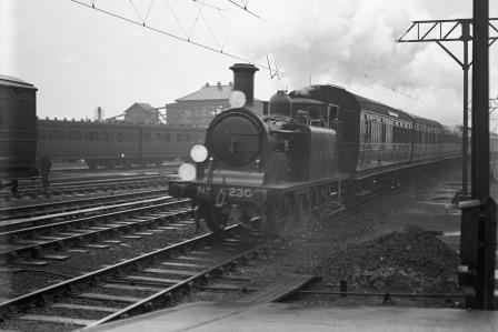 LBSCR D1 class 230 at Clapham Junction, Greater London with an ECS working to Eardley Carriage Sidings on Saturday 04 Mar 1922 - H.C. Casserley [270144]